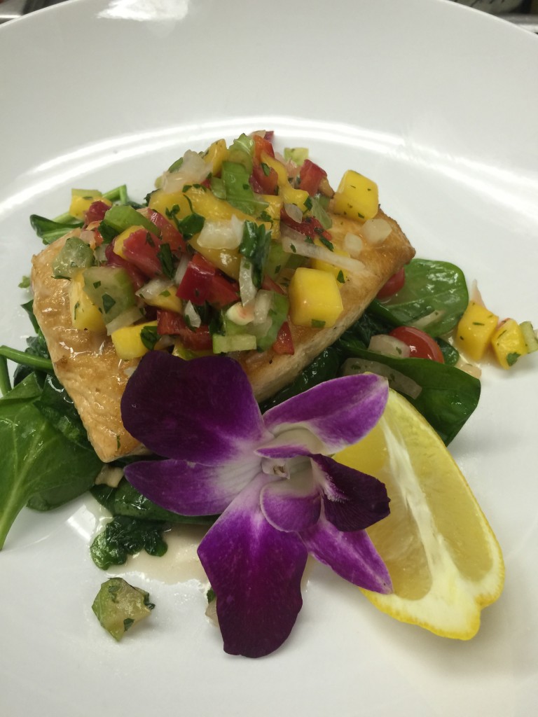 Mango Salsa with Strawberries and Pineapple served on Salmon with Sautéed Spinach and Grape Tomatoes